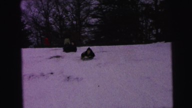 1964: kids are sliding down the hill on the snow CAMDEN, NEW JERSEY