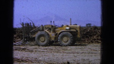 1965: an old yellow tractor sits upon rugged terrain at daytime MEXICO