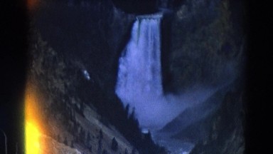 1967: waterfall pouring down high speed pure nature forest area YELLOWSTONE