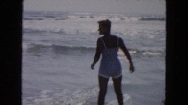 1961: happy family in vacation with their baby on a sunny beach MICHIGAN