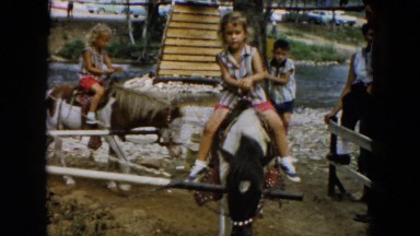 1961: little girls and little boys enjoying livestock, circular pony rides