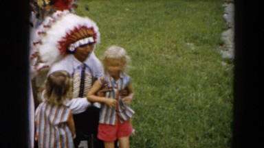 1961: indian dressed outdoor children sit lap talks down MICHIGAN