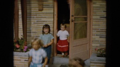 1961: four little girls run outdoor to play in their neighborhood