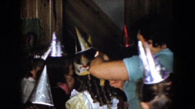 1961: a woman twirling around a young girl in a blindfold at a birthday party