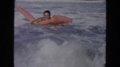 1961: various people playing on the beach and in the surf MICHIGAN