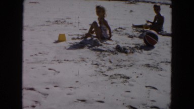 1961: young girls with mother on vacation at the beach