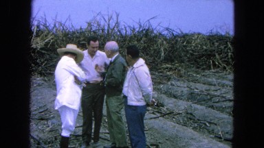 1965: Four Men Standing Outside in a Small Circle Talking Mexico