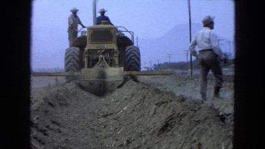 1965: men along a highway using machinery to dig a large ditch MEXICO