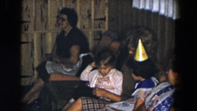 1961: Mother and Playful Children Sitting on Couch in Michigan