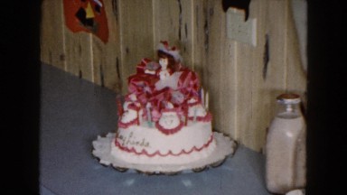 1961: a cake, decorated with a doll on top, sitting on a table MICHIGAN