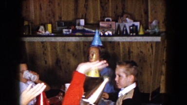1961: children at a birthday party sitting around the table with punch