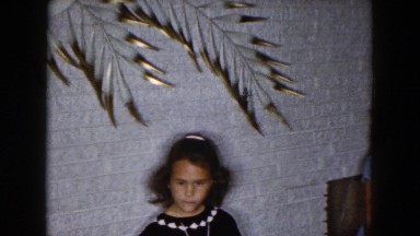 1961: young lady with two girl children walking to a white wall MICHIGAN