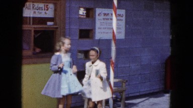 1961: two girls buy an entrance ticket at a ticket window and hand it to a blond
