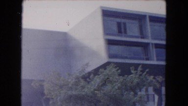 1961: building house apartment road moving cars two young girls alongside