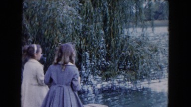 1961: Two Well-Dressed Young Girls Feeding Ducks at a Large Pond in Michigan
