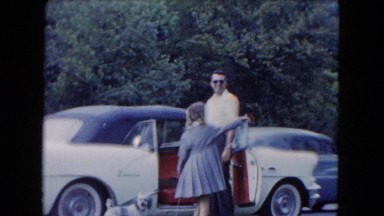 1961: man and girl with puppy near car pointing at traffic and running MICHIGAN