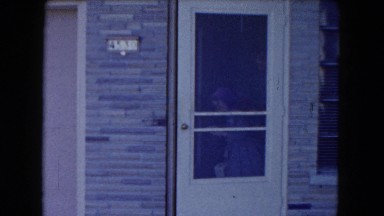 1961: two young girls exiting through the front door of a house MICHIGAN
