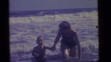 1964: mother teaches son how to swim on a beautiful hot sunny day. CAMDEN