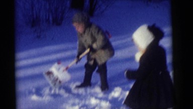 1964: a brother and sister playing with the snow on a frozen winter day CAMDEN