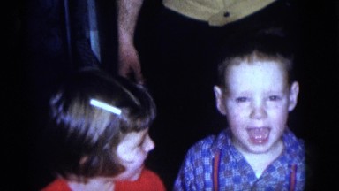 1964: a man kneeling to the floor and posing with three young children CAMDEN