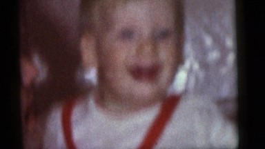 1964: small boy and his father laughing at each other. CAMDEN, NEW JERSEY