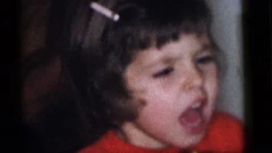 1964: children celebrate at a party with noisemakers while adults supervise
