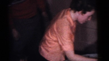 1964: a group of children sitting around a table being brought a cake