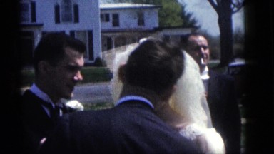 1964: a young man and woman get married in a yard beside a busy street