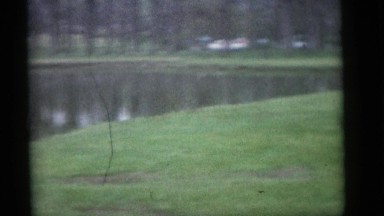 1964: a mother is holding her toddler boy at a lake