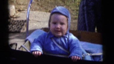 1964: a baby boy smiles in a cart. CAMDEN, NEW JERSEY