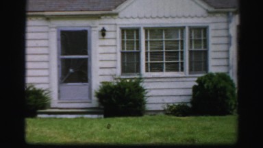 1956: A Charming White Craftsman Home with Yard, Shrubs, and Flowers in Boston