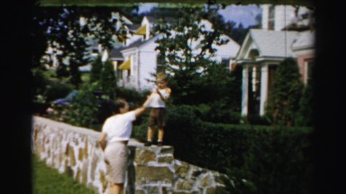 1956: kid standing on the wall and mother stands nearby BOSTON