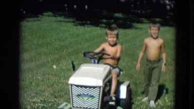 1963: Two Brothers Riding Lawn Mower in Yard Lincoln, Nebraska