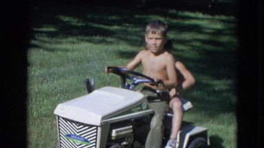1963: Two Cute Boys Riding a Small Cab on a Lawn in Lincoln, Nebraska