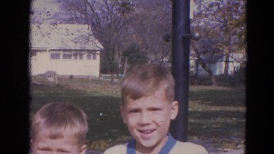 1963: two kids at a park on a sunny day wave at the camera LINCOLN, NEBRASKA