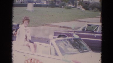1963: a woman in the open car is saying hi from it LINCOLN, NEBRASKA
