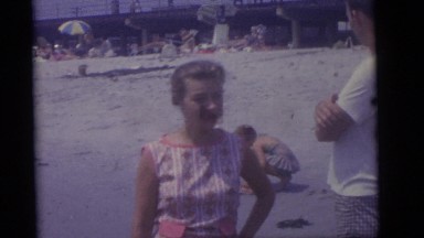 1964: a family playing in the sand and water on the beach CAMDEN, NEW JERSEY