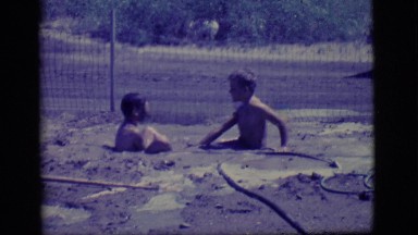 1968: children playing in the mud. COTTONWOOD, ARIZONA