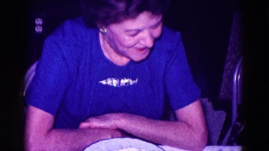 1968: older lady smiles at the camera while dining MINNESOTA