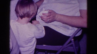 1968: a woman, who appears to be pregnant, wiping a child's nose MINNESOTA