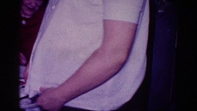 1968: pregnant woman adjusting maternity shirt stroking belly by child MINNESOTA