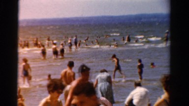 1954: many people are recreating in the shallow water of the beach. OHIO