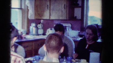 1954: eight people eating at a kitchen table together OHIO