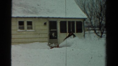 1954: man and child clearing snow with blower in front of house in yard OHIO
