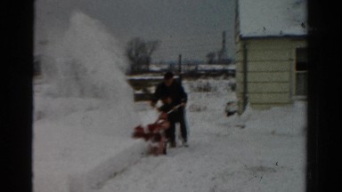 1954: a man using his small but powerful new snow cleaning machine OHIO