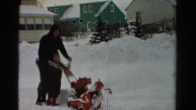 1954: a father and son push a snow plow on a cold winter's day OHIO