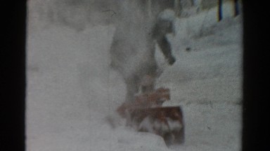 1954: man and boy using snowblower after snowfall OHIO