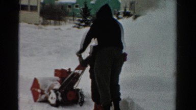 1954: a man teaching a child how to use a snow-blower OHIO