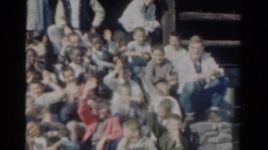 1954: Panoramic Video of Children Sitting on Building Steps Waving at Camera