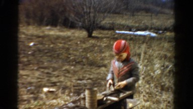 1954: child playing in the woods while blowing bubble gum bubbles OHIO